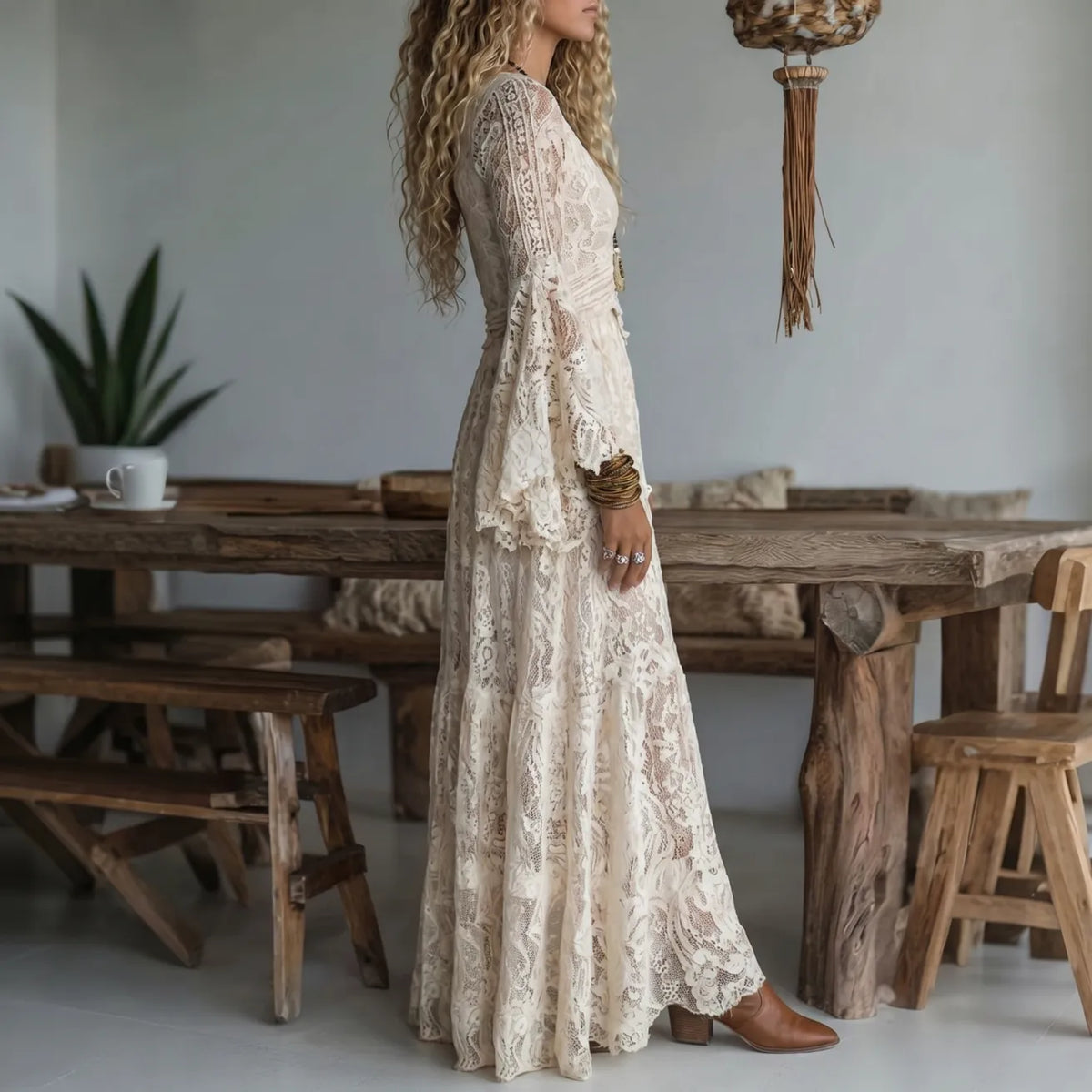 Ivory lace maxi dress in side profile with long sleeves and flowing tiered skirt