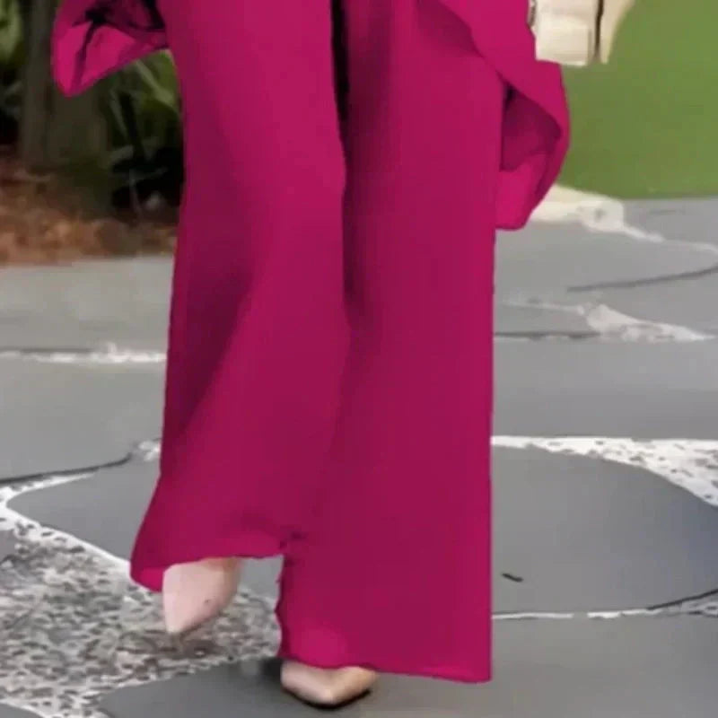 Pink wide-leg pants with flowing drape and matching draped top, two-piece set