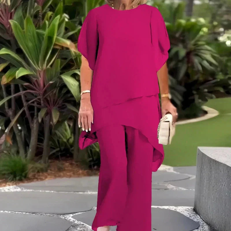 Pink two-piece set with draped short-sleeve top and matching wide-leg pants