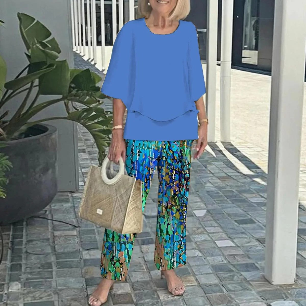 Blue two-piece set with layered top and teal floral wide-leg pants