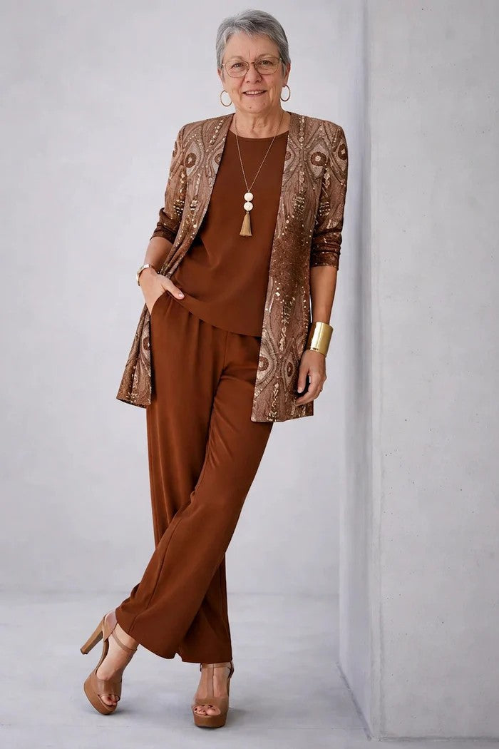 3-piece set in rust brown with shimmering jacket, floral top, and relaxed straight-leg pants.
