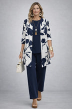 3-piece set in navy blue with bold leaf-print long jacket, solid top, and cropped pants.