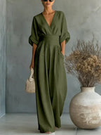 Olive green V-neck high-waist jumpsuit with cinched waist and wide-leg flow, dolman sleeves